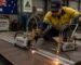 A tradesman using a Quickie Track Cutting Machine and Gas Beetle Plate Cutter on a steel plate in an Australian fabrication workshop